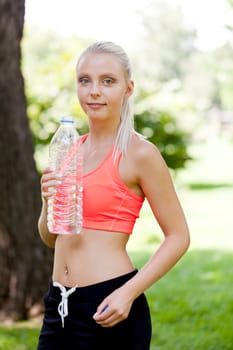 attractive young blonde woman drinking water outdoor sport in summer