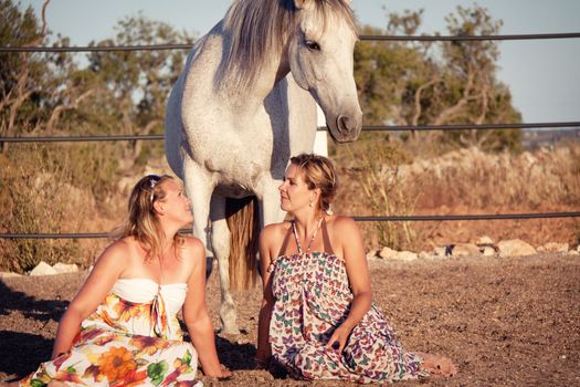 two woman horse and dog outdoor in summer happy sunset together nature