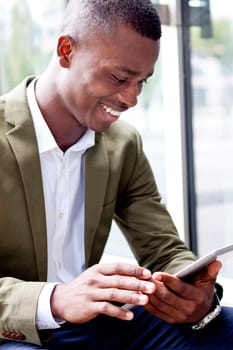 smiling successful businessman with tablet pc outdoor in summer 