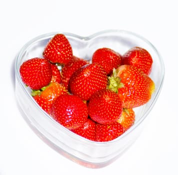 Strawberry in glass plate on white background