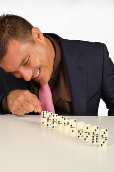 Guy having fun with a row of domino stones