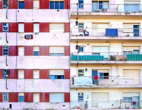 Facades of two poor apartment buildings in La Boca neighborhood of Buenos Aires