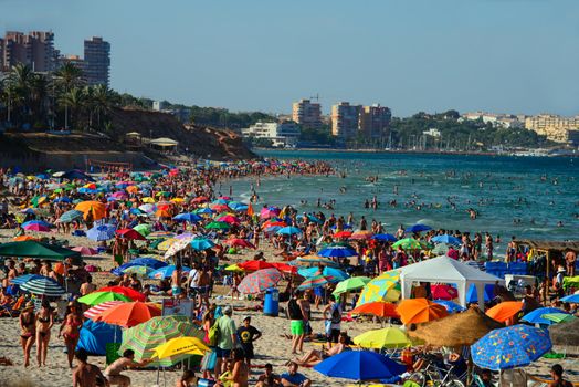 A Spanish beach in summer crowded with tourists