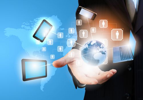 Image of business person holding devices in hands