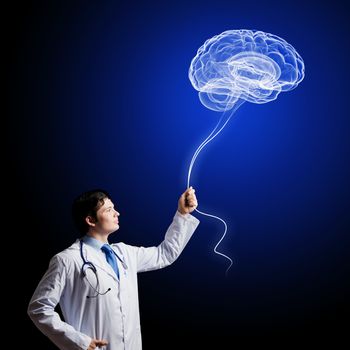 Image of young doctor neurologist against dark background