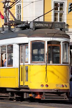 Yellow tram on narrow street, Alfama district of Lisbon. Portugal 