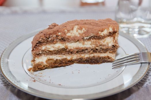 Tiramisu is made of biscuits dipped in coffee, layered with a whipped mixture of egg yolks and mascarpone, and flavored with liquor and cocoa.