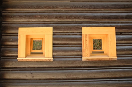 Wooden wall with two small windows.