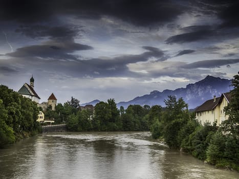Picture of river Lech in Fussen with historic church and alps in Germany