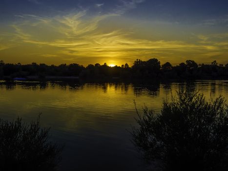 Sunset with blue and golden colors on a lake in Bavaria