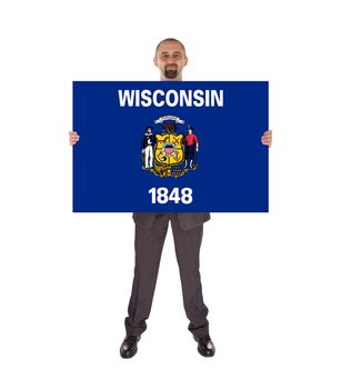Smiling businessman holding a big card, flag of Wisconsin, isolated on white