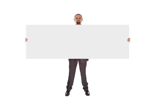 Smiling businessman holding a really big blank card, isolated on white