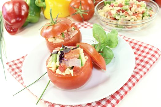 stuffed tomatoes with pasta salad and cress on a light background