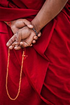 Tibetan Buddhism - prayer beads in Buddhist monk hands. Ladakh, India