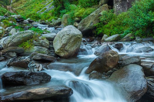 Cascade falls over mossy rocks