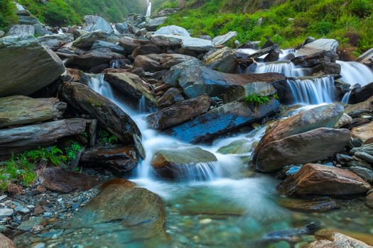 Cascade of Bhagsu waterfall in Himalayas. Bhagsu, Himachal Pradesh, India. Polarizer filter used