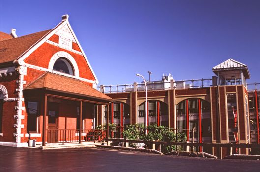 red building and red parking garage in a city