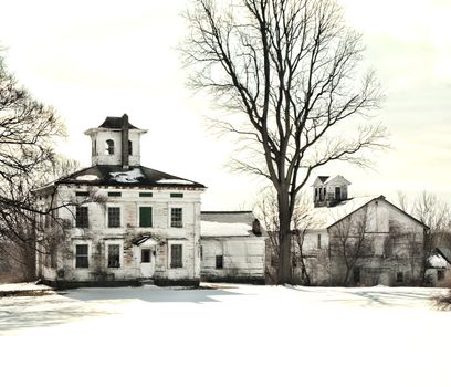 abandoned old farmhouse and barn in winter