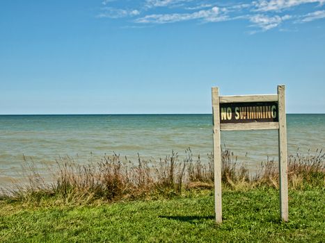 no swimming sign on the shores of lake ontario, huron,new york