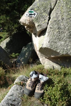 Trail signs and trekking shoes somewhere in karkonosze mountains