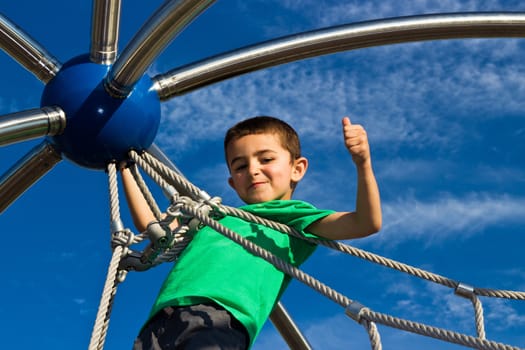 Child playing on the play structure in the park