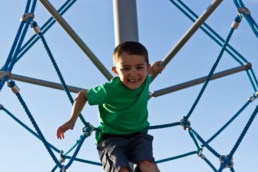 Child playing on the play structure in the park
