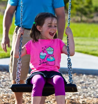 Family playing on the swing set