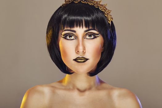 Close-up portrait of a beautiful girl with an evening make-up and jewelery