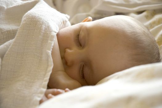 Sleeping baby girl sleeps in her bed