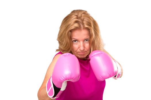 A blonde woman wearing a pink blouse and a pink gloves.
