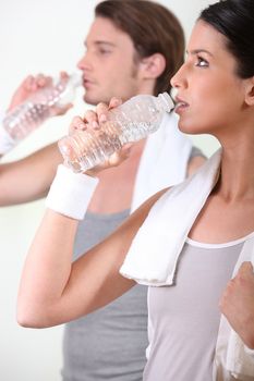 a couple drinking water after sport