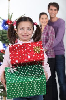 little girl receiving her Christmas presents