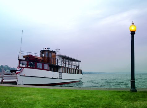 old wooden tour boat docked on a summer morning