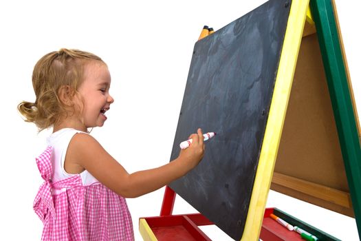 Sweet little girl learning happily in front of her blackboard