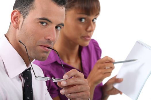 Business couple writing in a pad