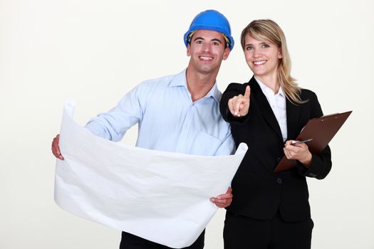 female architect and foreman holding plans