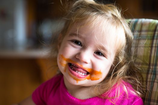 Baby girl finished eating her food and left big mess around her mouth