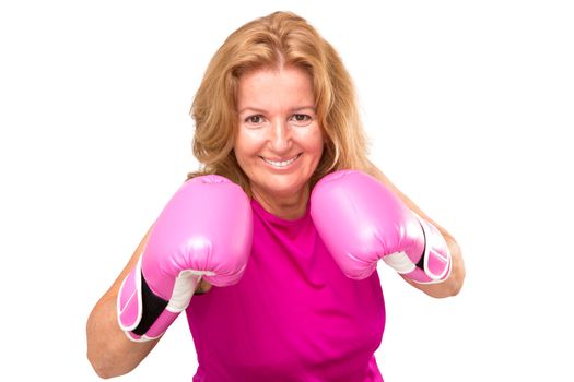 Happy female boxer with her pink gloves guarding herself and getting ready to attack