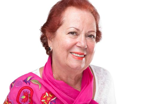 Older woman with red hair smiling to camera with her red scarf on her shoulders. She has a proper smile on her face. Isolated on white.