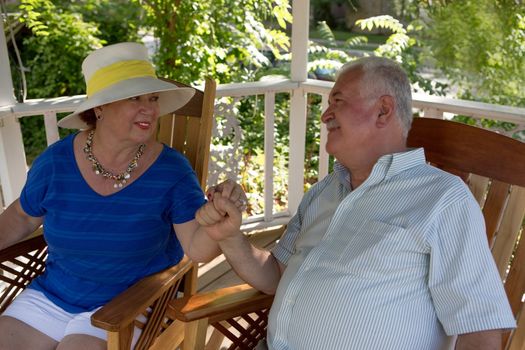 Portrait of mature couple sitting on the terrace while talking