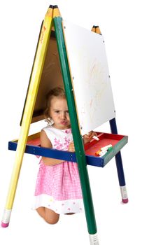 Tricks mischievous girl hiding in between whiteboard legs not happy to do homework