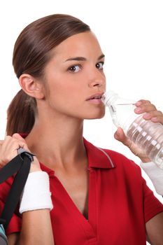 Woman drinking water after sport