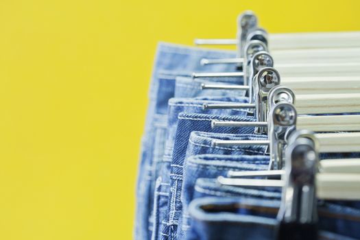 Row of hanged blue jeans