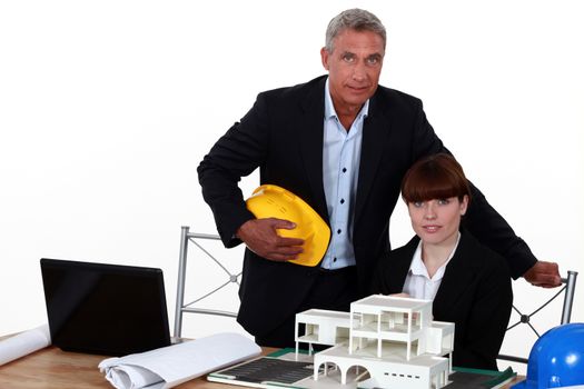 female architect in office with male counterpart