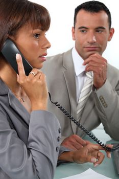 Man observing his colleague on the phone