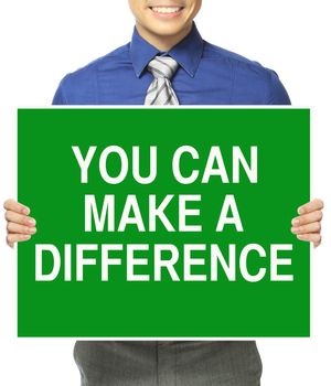 A man in office attire holding a sign with a motivational message