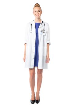Portrait of a beautiful female doctor with a sincere friendly smile standing facing the camera, full length on white