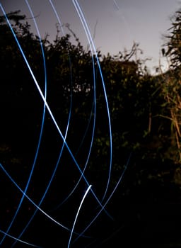 Circular light streams on a dark outdoor background
