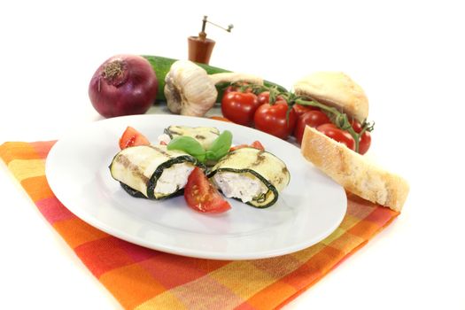 stuffed zucchini rolls with cream cheese on a light background