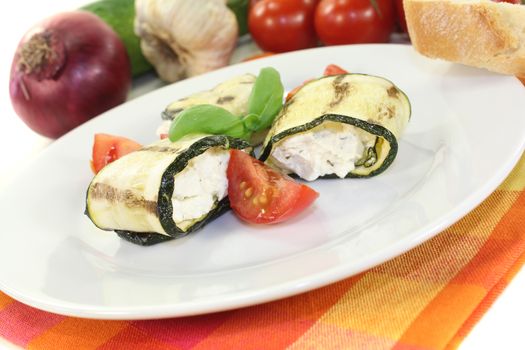 delicious stuffed zucchini rolls with cream cheese on a light background